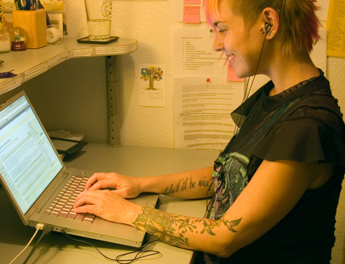 Girl typing article on computer Girl typing article on computer